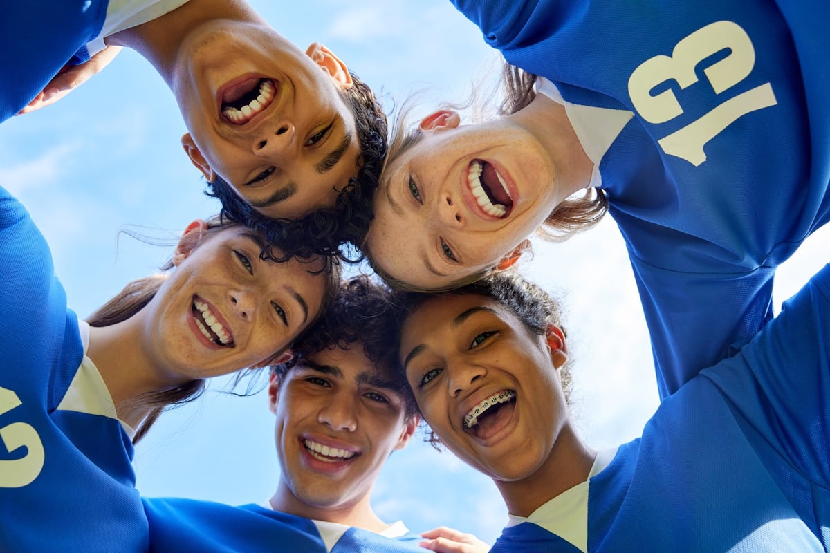 Youth sports team in a close huddle