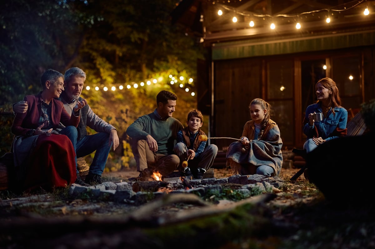 Multigenerational family around campfire