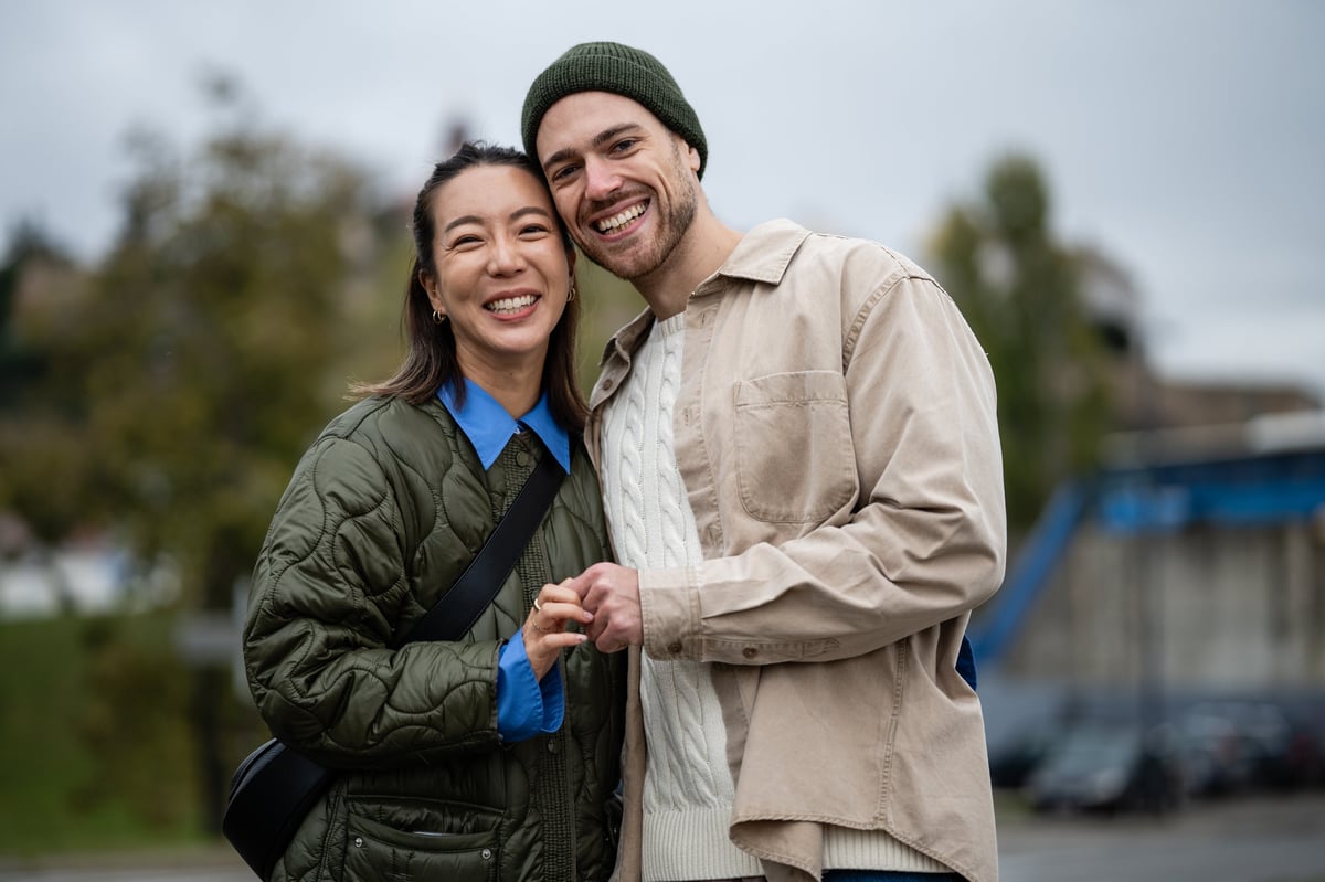 Smiling couple holding hands outdoors
